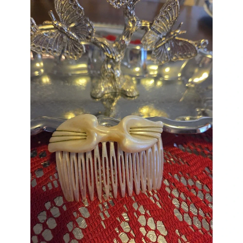 T.Z. Inc. 1981 vintage hair comb is made of faux mother-of-pearl cellulose...